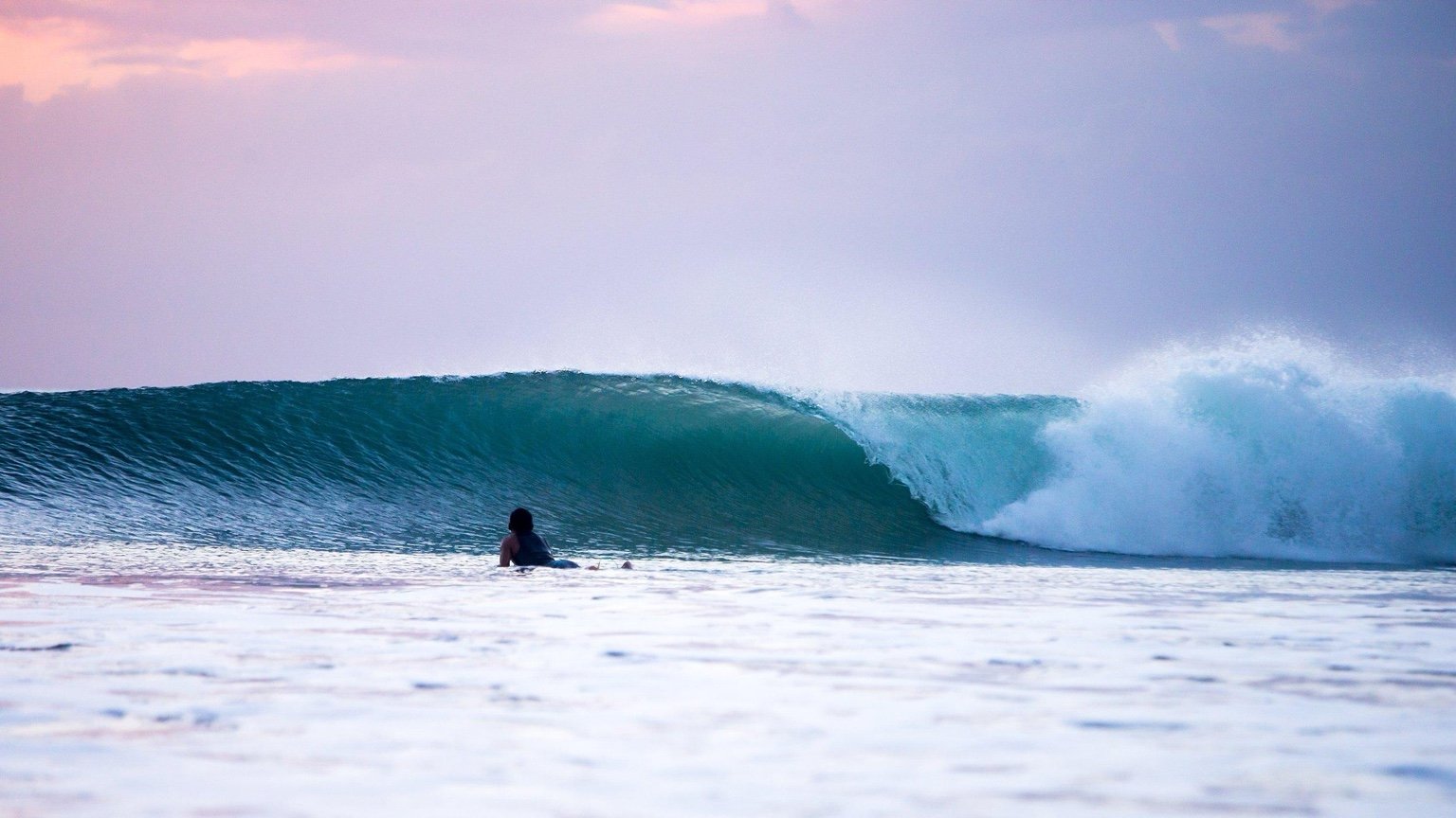 Halfway surf wave photographed at sunset